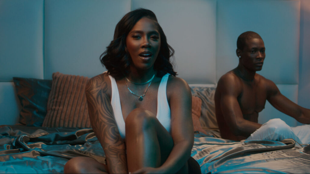 Color Correction example. Black woman on brown bed, illuminated by warm and blue light.